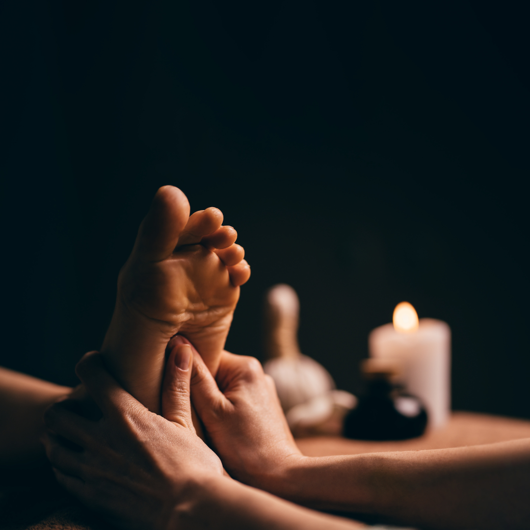 Reflexology therapy — candlelit foot massage with candle